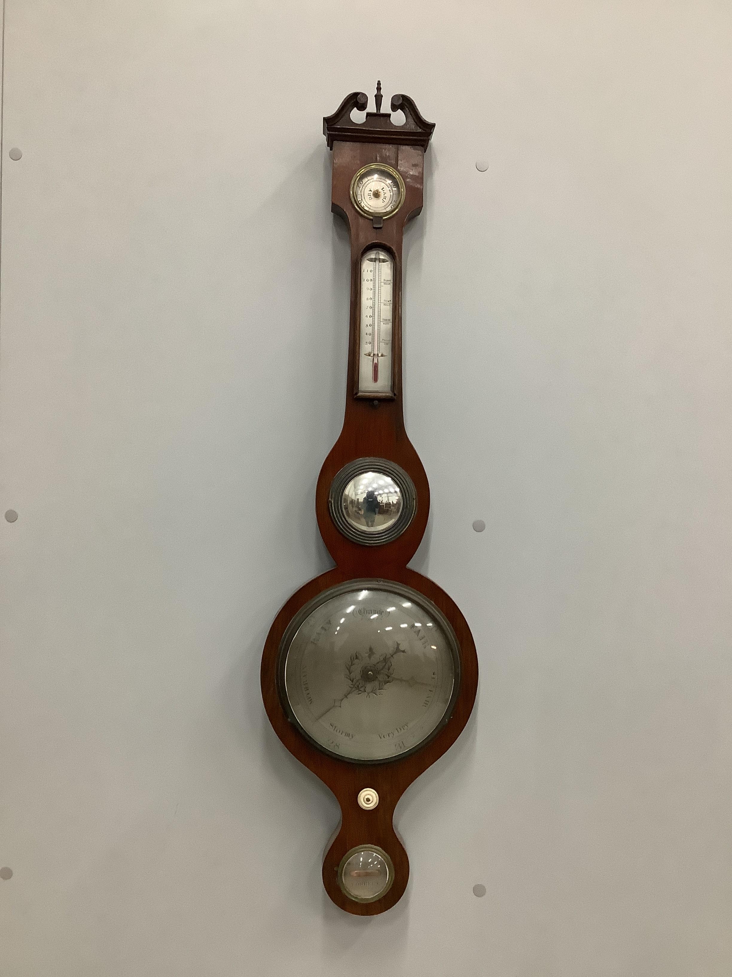An early 19th century mahogany wheel barometer and thermometer, incorporating a level, a convex mirror and a hygrometer, height 97cm